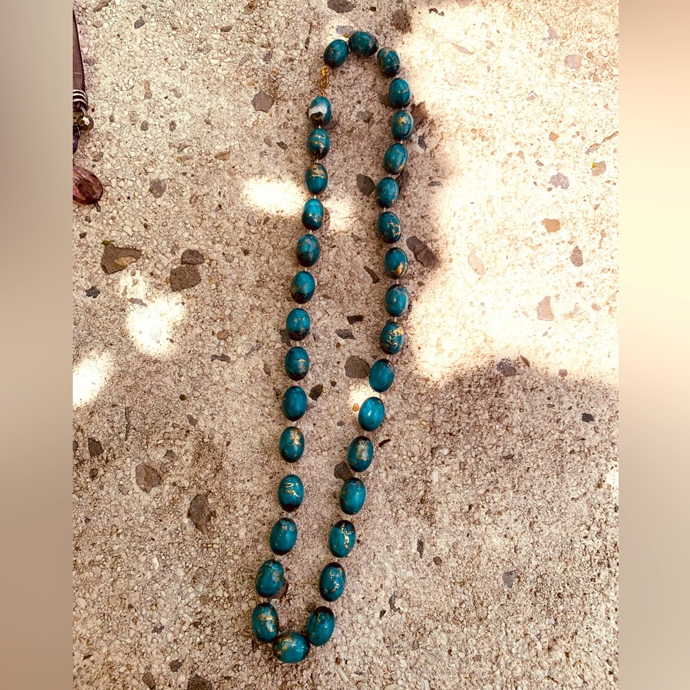 Turquoise beads with gold accents makes this necklace. Nice beachy touch.